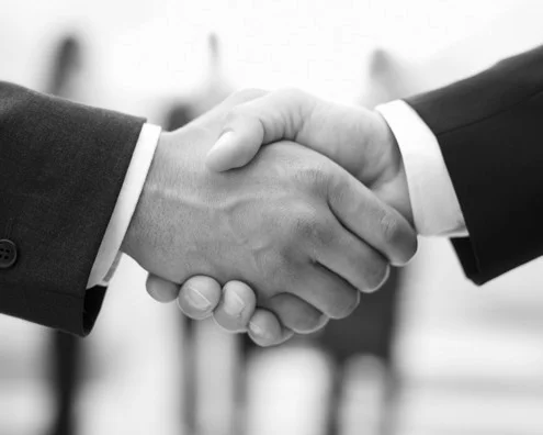 HomePhotoLarge_HandShake-495x396-greyscale